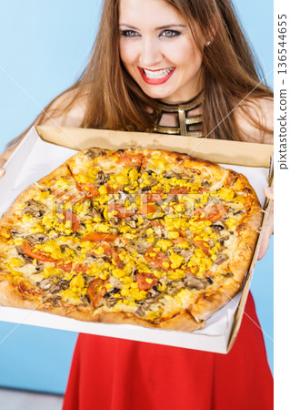Woman holding big pizza in box Woman holding big pizza in box 136544655