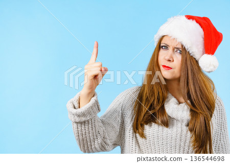 Woman threatens with finger, serious face expression Woman threatens with finger, serious face expression 136544698