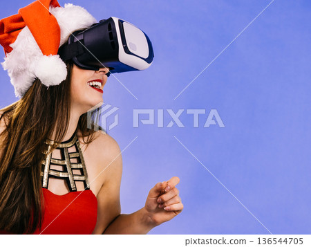 Girl watching 3d film tour in virtual reality glasses. 136544705