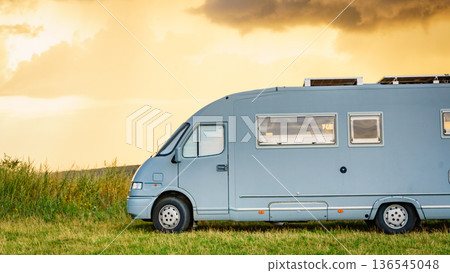 Sunset sky over caravan camping on nature. Sunset sky over caravan camping on nature. 136545048