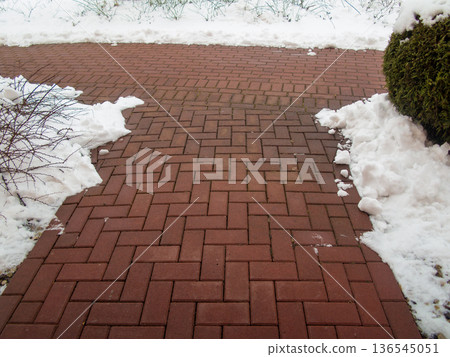Garden stone path with snow. Brick sidewalk. Garden stone path with snow. Brick sidewalk. 136545051