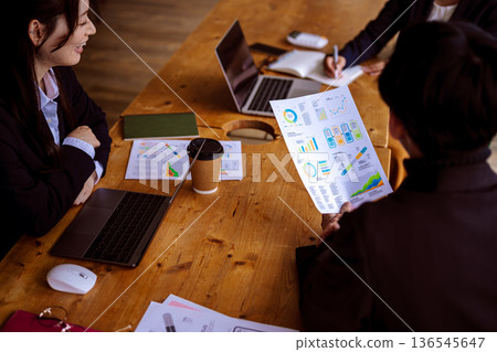Reviewing materials at a meeting Reviewing materials at a meeting 136545647
