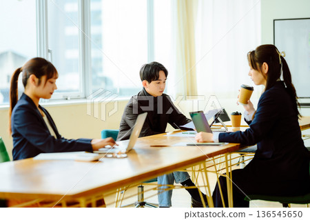 Working on a PC during a meeting Working on a PC during a meeting 136545650