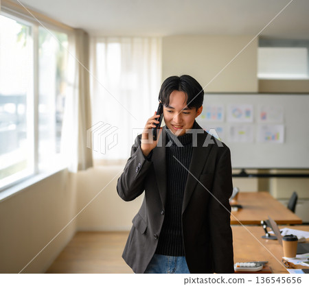 A man is answering the phone 136545656