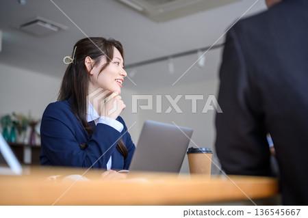 A woman speaks with a smile 136545667