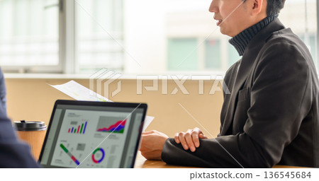 Reviewing materials at a meeting 136545684