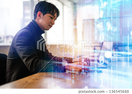 A man working on a PC 136545688