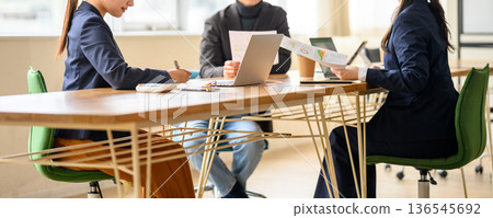 Reviewing materials at a meeting 136545692