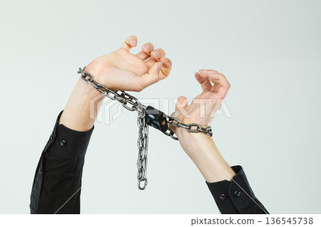 Man with chained hands, no freedom 136545738