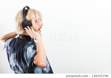 cool guy having fun listens to music in headphones 136545740