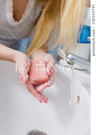 Female washing her hands, using soap 136545745