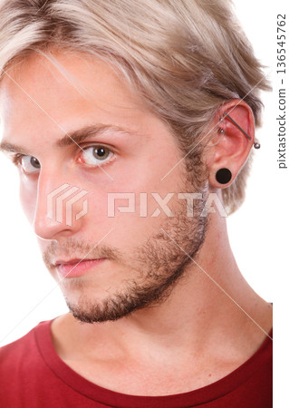 Teen boy with piercing and fashionable hairstyle Teen boy with piercing and fashionable hairstyle 136545762