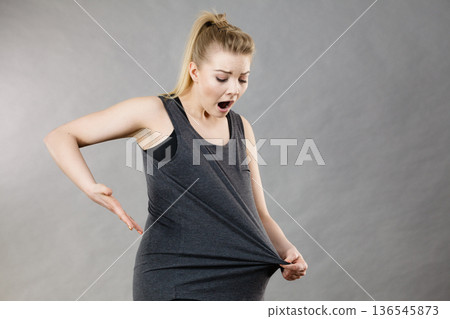 Woman wearing too big tshirt 136545873