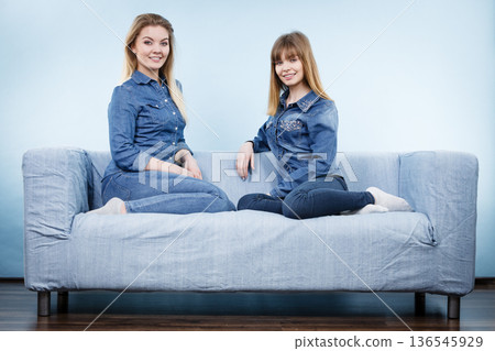 Two happy women friends wearing jeans outfit 136545929