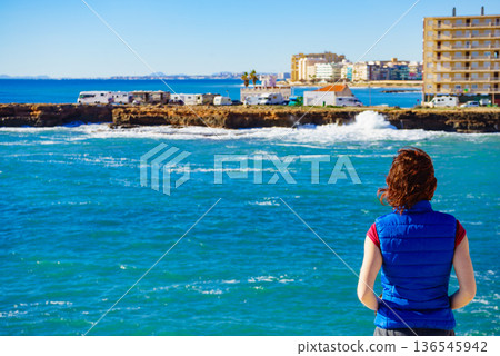 Tourist woman on sea cliffs in Spain Tourist woman on sea cliffs in Spain 136545942
