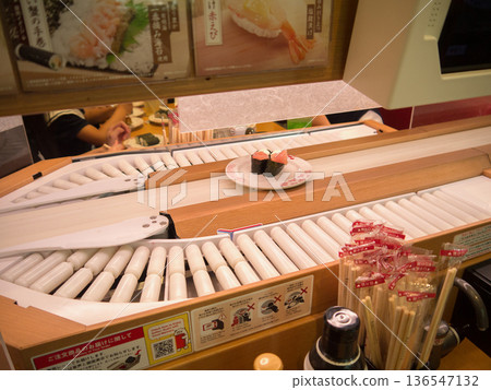 Sushi plates flowing on a conveyor Sushi plates flowing on a conveyor 136547132
