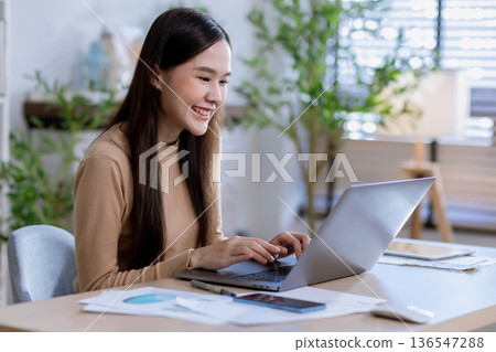 Business woman at desk in office for celebration of goals or target. Business woman at desk in office for celebration of goals or target. 136547288