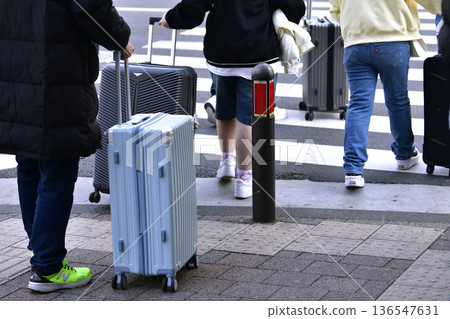 Yokohama cityscape in Japan. Inbound tourism continues... In front of Sakuragicho Station. Foreign tourists crossing the crosswalk... suitcases... Yokohama cityscape in Japan. Inbound tourism continues... In front of Sakuragicho Station. Foreign tourists crossing the crosswalk... suitcases... 136547631
