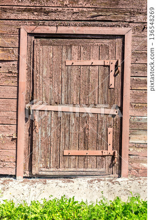 Old wooden door with metal padlock 136548269