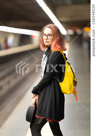 Young woman waiting on underground subway platform 136548520