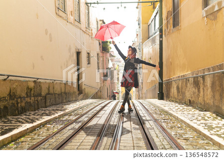 Young woman enjoying city exploring on tram track Young woman enjoying city exploring on tram track 136548572