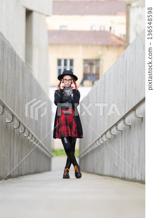 Stylish young woman thinking with hands on temples Stylish young woman thinking with hands on temples 136548598