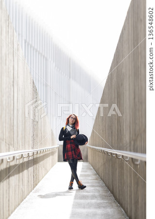 Young woman walking confident in modern urban passage Young woman walking confident in modern urban passage 136548602