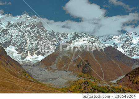A trekking trail to the Shkhara Glacier from Ushguli. An autumn valley in the Caucasus Mountains. 136549204