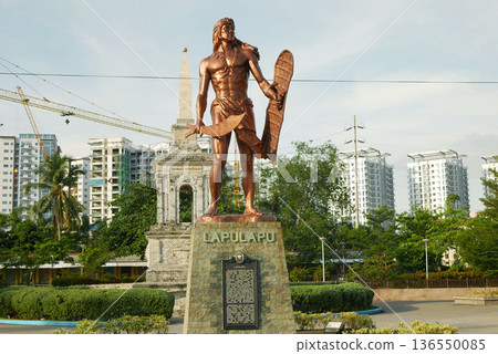 Datu Rajah Lapu-Lapu liberty shrine monument bronze statue holding a native sword kampilan and wooden shield kalasag standing in pedestal. Filipino hero sculpture leading the native warriors who 136550085