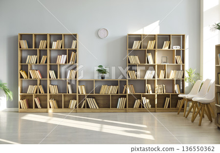 Modern reading room with wooden bookshelves, chairs and bright sunlight interior 136550362