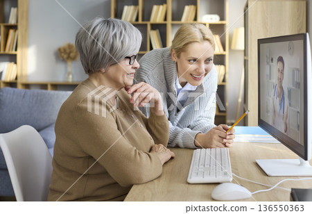 Senior woman and daughter video call with online doctor for telemedicine care Senior woman and daughter video call with online doctor for telemedicine care 136550363