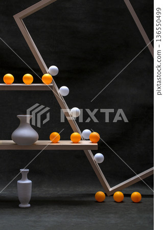 Still life with white vases and white and orange balls on wooden shelves Still life with white vases and white and orange balls on wooden shelves 136550499
