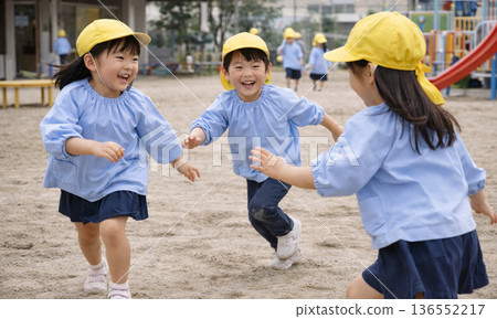 Smiling children playing energetically in the school yard Smiling children playing energetically in the school yard 136552217