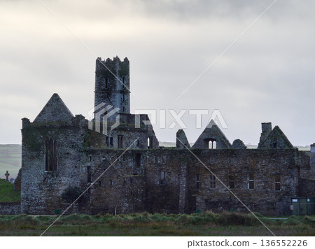 Historic Abbey ruins in Ireland stand under a cloudy morning sky. Historic Abbey ruins in Ireland stand under a cloudy morning sky. 136552226