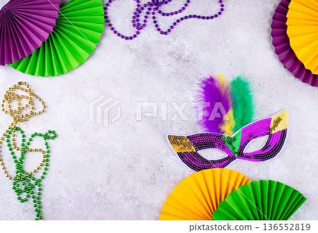 Vibrant Mardi Gras background with mask, beads, and festive decorations 136552819