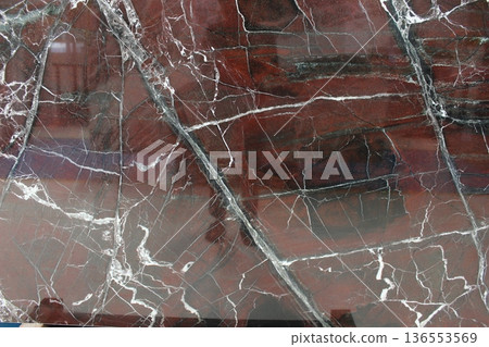 Rosso Levanto marble texture from Italy featuring deep maroon red color and majestic contrasting white veins. 136553569