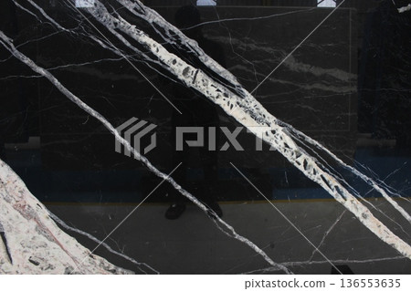 Detail of Portoro Silver black marble surface with light reflection on diagonal white vein textures. Detail of Portoro Silver black marble surface with light reflection on diagonal white vein textures. 136553635