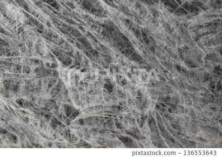 Texture of Grey William marble in grey with interlocking white mineral fibers forming an artistic natural mesh pattern. Texture of Grey William marble in grey with interlocking white mineral fibers forming an artistic natural mesh pattern. 136553643