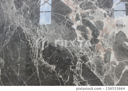 Grigio Carnico marble texture from Italy featuring a dark grey background and intersecting white veins. 136553664