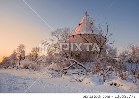 A winter scene with a snow-covered landscape and an ancient fortress. A winter scene with a snow-covered landscape and an ancient fortress. 136553772