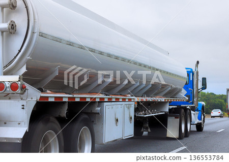 Truck transports fuel on highway in typical road setting 136553784