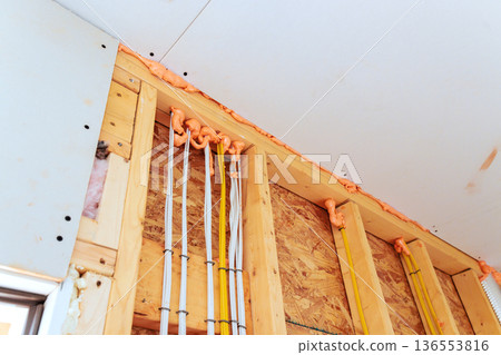 Construction work shows electrical wires fire fighting insulation in building during renovation 136553816