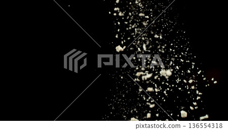 Falling white powder, flour particles floating and dispersing in air, isolated on black background. Detailed texture and dynamic dust cloud effect. Falling white powder, flour particles floating and dispersing in air, isolated on black background. Detailed texture and dynamic dust cloud effect. 136554318
