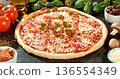 Closeup of black olives falling onto fresh pizza with tomato sauce, mozzarella and ham. Dynamic food motion highlights texture, freshness and Italian pizza preparation concept. 136554349
