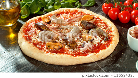 Prepared pizza dough with tomato sauce and mozzarella. Italian pizza preparation on rustic wooden table. Prepared pizza dough with tomato sauce and mozzarella. Italian pizza preparation on rustic wooden table. 136554353