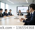 A Japanese woman in a business suit talking with a serious expression in an office conference room. Work, career, consultation 136554368