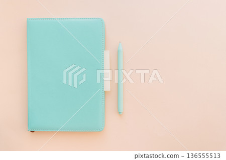 Turquoise notebook with pen and sticky note on pastel background, copy space 136555513