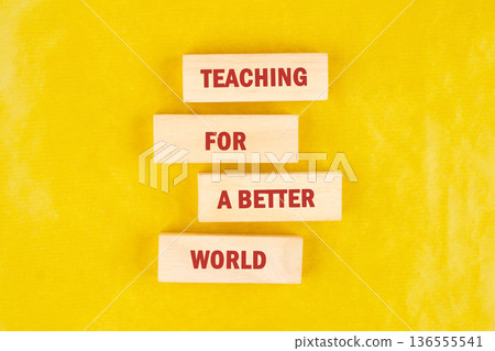 Four light wooden blocks display Teaching For A Better World in red text 136555541