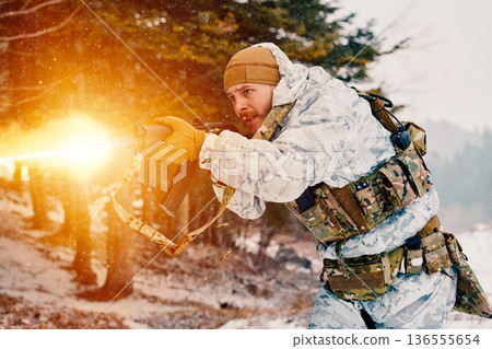 Soldier Firing Assault Rifle During Winter Military Training In Snowy Woodland Combat Exercise 136555654