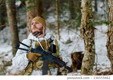 Winter Soldier In Camouflage Gear With Rifle On Patrol In Snowy Forest Landscape 136555662